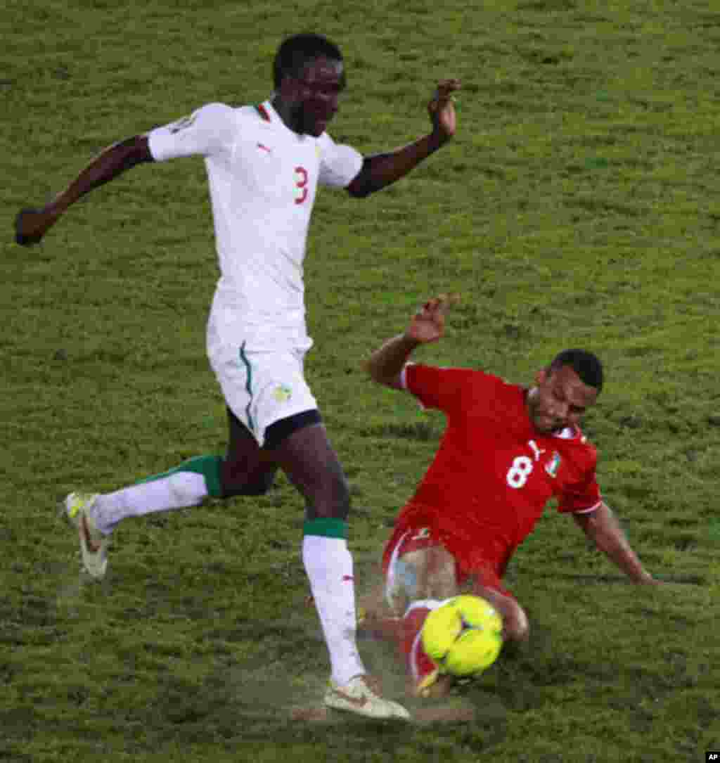 Iyanga of Equatorial Guinea challenges Sane of Senegal during their African Nations Cup Group A soccer match at Estadio de Bata