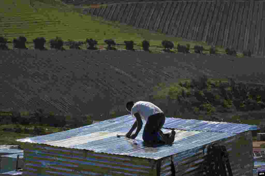 People lay out plots and build shacks on a piece of land belonging to the Louiesenhof Wine Estate in Stellenbosch, which is at the centre of the South African wine-producing region.