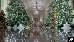 The Cross Hall leading into the State Dinning Room is decorated during the 2019 Christmas preview at the White House, Monday, Dec. 2, 2019, in Washington.