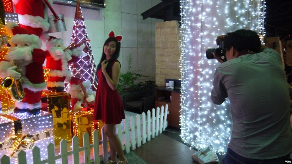 shoppers take photos in front of christmas decorations at a mall in ho chi minh city - Is Christmas A Religious Holiday shoppers take photos in front of christmas decorations at a mall in ho chi minh city - Is Christmas A Religious Holiday