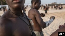 A young Dambe boxer wears good luck charms around his neck on March 2, 2018.