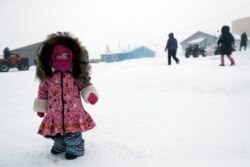 A girl waits for her mother, Jan. 19, 2020, in Toksook Bay, Alaska.