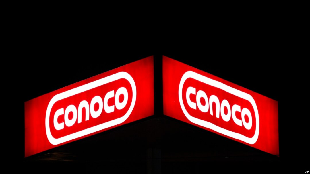 FILE - A Conoco sign at night in Dallas, Oct. 25, 2011. 