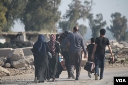 Families continue to flee urban areas of western Mosul as Iraqi forces fight IS militants on March 10, 2017. (H. Murdock/VOA)