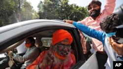 Sakshi Maharaj, an accused in the 1992 attack and demolition of a 16th century mosque, celebrates as he leaves a court in Lucknow, India, Sept. 30, 2020. 