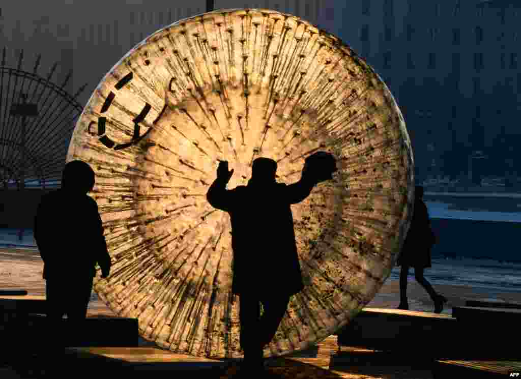 A man cleans a zorb ball outside the Gorky Park at sunset in Moscow, Russia.