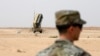 FILE - A member of the U.S. Air Force stands near a Patriot missile battery at the Prince Sultan air base in al-Kharj, central Saudi Arabia, Feb. 20, 2020. 