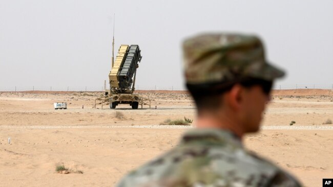 FILE - A member of the U.S. Air Force stands near a Patriot missile battery at the Prince Sultan air base in al-Kharj, central Saudi Arabia, Feb. 20, 2020.