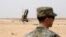 FILE - A member of the U.S. Air Force stands near a Patriot missile battery at the Prince Sultan air base in al-Kharj, central Saudi Arabia, Feb. 20, 2020. 