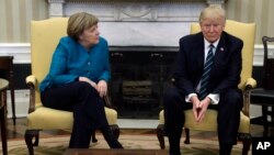 FILE - President Donald Trump meets with German Chancellor Angela Merkel in the Oval Office of the White House in Washington, March 17, 2017.