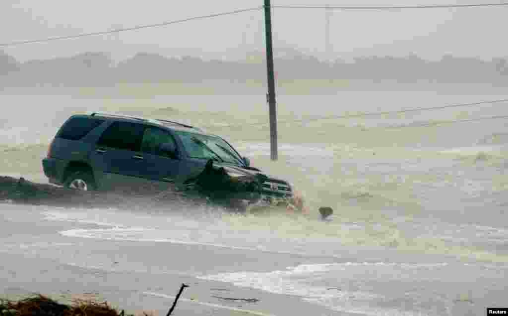 A car is surrounded by floodwaters from Hurricane Harvey in Point Comfort, Texas, Aug. 26, 2017.