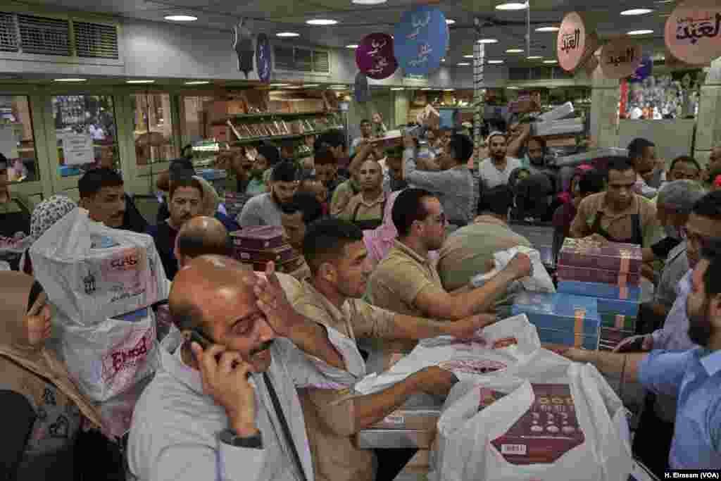 Some would say that no Eid feast in Egypt is complete without the cookies known as “Kahk.” Cairo residents line up at a confectioner’s in central Cairo to buy them fresh for the celebration. 