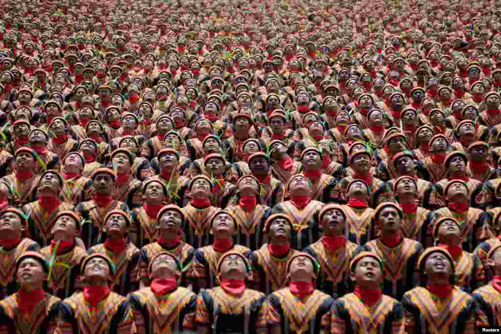 People, including police and military, take part in a traditional Saman dance which originates from the Gayo ethnic group in Gayo Lues District, Aceh province, Indonesia, in this photo taken by Antara Foto.