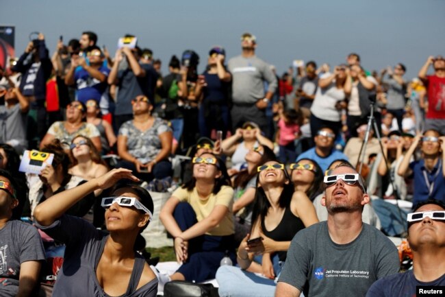 FILE - People watch the solar eclipse on the lawn of Griffith Observatory in Los Angeles, California, U.S., August 21, 2017. (REUTERS/Mario Anzuoni/File Photo)