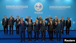 A group photograph of the SCO heads of state, the heads of observer states and governments, and international organization delegation heads during the Shanghai Cooperation Organization (SCO) summit in Ufa, Russia, July 10, 2015.