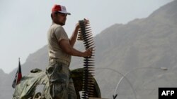 An Afghan border policeman takes position following clashes with Pakistani forces on the border between Afghanistan and Pakistan in eastern Nangarhar province, June 15, 2016.