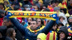 A pro-Catalan supporter holds a banner during a demonstration near the EU quarter in Brussels on Thursday, Dec. 7, 2017.