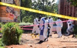Ugandan explosives experts secure the scene of an explosion in Komamboga, a suburb on the northern outskirts of Kampala, Uganda, Oct. 24, 2021.
