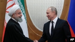 FILE - Russian President Vladimir Putin, right, and Iranian President Hassan Rouhani shake hands prior to the talks in the Bocharov Ruchei residence in the Black Sea resort of Sochi, Russia, Feb. 14, 2019.