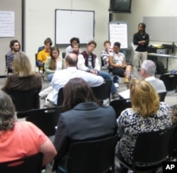 A student actor shares his character’s reactions with participants. Skyler Jackson (R-standing) leads the Creating Bias-Free Classrooms teacher training.