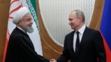 Russian President Vladimir Putin, right, and Iranian President Hassan Rouhani shake hands prior to the talks in the Bocharov Ruchei residence in the Black Sea resort of Sochi, Russia, Feb. 14, 2019.