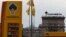 The logo of Russia's top crude producer Rosneft is seen on a price information board of a gasoline station in Moscow July 17, 2014.