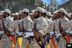FILE - Members of Iran's Islamic Revolutionary Guard Corps march just outside Tehran during an armed forces parade, Sept. 22, 2011.