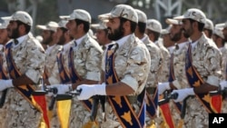 FILE - Members of Iran's Islamic Revolutionary Guard Corps march just outside Tehran during an armed forces parade, Sept. 22, 2011. 