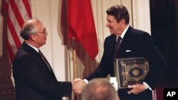 FILE - U.S. President Ronald Reagan, right, shakes hands with Soviet leader Mikhail Gorbachev after the two leaders signed the Intermediate Range Nuclear Forces Treaty, Dec. 8, 1987.