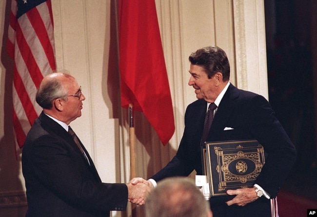 FILE - U.S. President Ronald Reagan, right, shakes hands with Soviet leader Mikhail Gorbachev after the two leaders signed the Intermediate Range Nuclear Forces Treaty, Dec. 8, 1987. (AP Photo/Bob Daugherty, File)