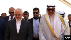A handout photo released by the Kuwaiti news agency KUNA shows Kuwaiti Foreign Minister Sheikh Sabah al-Khaled al-Sabah (R) receiving his Iranian counterpart Mohammad Javad Zarif following his arrival at Kuwait international airport in Kuwait City, July 26, 2015.