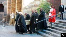 The coffin of Archbishop Emeritus Desmond Tutu is carried from St. George's Cathedral where he laid in state in Cape Town, South Africa, Dec. 30, 2021. 