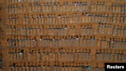 FILE - An aerial view of crosses casting shadows at the Parque Taruma cemetery is seen amid the coronavirus pandemic, in Manaus, Brazil, June 15, 2020.