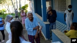 An elderly woman waits to get a dose of the Pfizer COVID-19 vaccine during a booster shot campaign for elderly residents in long-term care institutions, at Casa de Repouso Laco de Ouro nursing home in Rio de Janeiro, Brazil, Sept. 2, 2021.