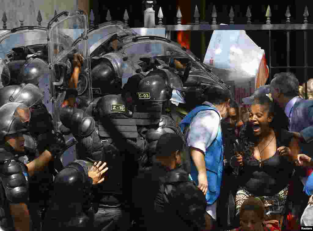 Squatters react as they are evicted from a abandoned building in Flamengo neighborhood, in Rio de Janeiro, Brazil.