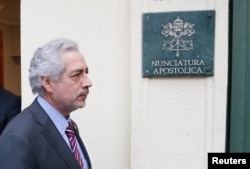 FILE - Chilean prosecutor Raul Guzman is seen after a meeting with special Vatican envoys Archbishop Charles Scicluna and Father Jordi Bertomeu inside the apostolic nunciature in Santiago, Chile, June 13, 2018.