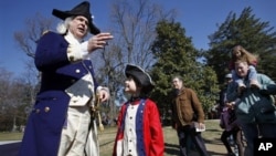 Lewis Bliss, 10, of Burke, Va., dressed in a musicians outfit from the Revolutionary War era, center, meets George Washington, portrayed by Dean Malissa, during Presidents Day activities at George Washington's Mount Vernon Estate in Mount Vernon, Virginia