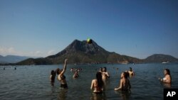 People enjoy the good weather, sea and sun in Adrasan on Turkey's Mediterranean, June 19, 2021.