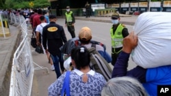 Los venezolanos utilizan el Puente Internacional Simón Bolívar para regresar a su país después de retornar desde La Parada, cerca de Cúcuta, Colombia, el sábado 14 de marzo de 2020.