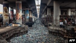 FILE - A general view of a clogged up canal filled with styrofoam and single use plastic at Obalende in Lagos on January 23, 2024.