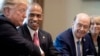 FILE - Scott Turner, second from left, leader of the White House Opportunity and Revitalization Council, shakes hands with U.S. President Donald Trump at a White House meeting, April 4, 2019. Turner is Trump's pick to lead the housing department in his second administration.