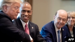 FILE - Scott Turner, second from left, leader of the White House Opportunity and Revitalization Council, shakes hands with U.S. President Donald Trump at a White House meeting, April 4, 2019. Turner is Trump's pick to lead the housing department in his second administration.