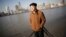 Chinese-born U.S. scientist Hu Zhicheng stands at the waterfront promenade along the Huangpu River in Shanghai, China, January 2013.