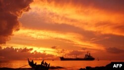 A fishing boat heads out to sea in the early morning in Lhokseumawe, Aceh, Indonesia.