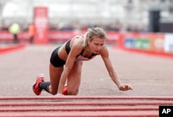 FILE - Great Britain's Hayley Carruthers advances to the finish line in the women's race at the 39th London Marathon in London, Sunday, April 28, 2019. (AP Photo/Alastair Grant)