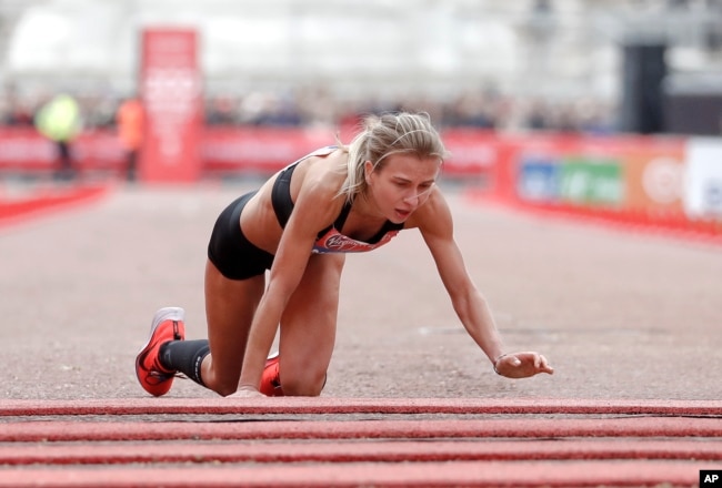 FILE - Great Britain's Hayley Carruthers advances to the finish line in the women's race at the 39th London Marathon in London, Sunday, April 28, 2019. (AP Photo/Alastair Grant)
