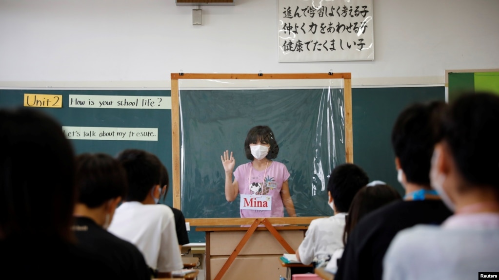 Tại một lớp học ở Nhật: Một sinh viên trình bày thuyết trình của mình sau tấm nhựa chắn nước bọt, Funabashi, Tokyo, tháng Bảy, 2020.