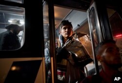 Central American migrants arrive in a bus at a shelter for migrants in Tijuana, Mexico, Nov. 20, 2018.