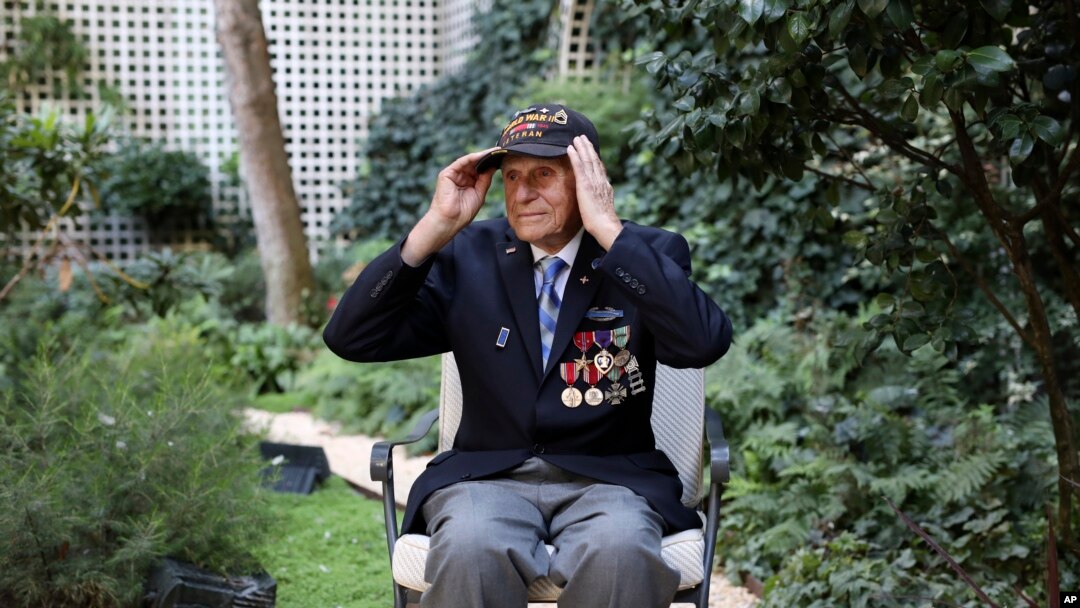Steven Melnikoff, 99, one of the few veterans left who took part to the D-Day landings on June 06, 1944, adjusts his cap during an interview with the Associated Press Friday, Aug.23, 2019.