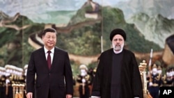 资料图：中国与伊朗领导人在北京会晤。